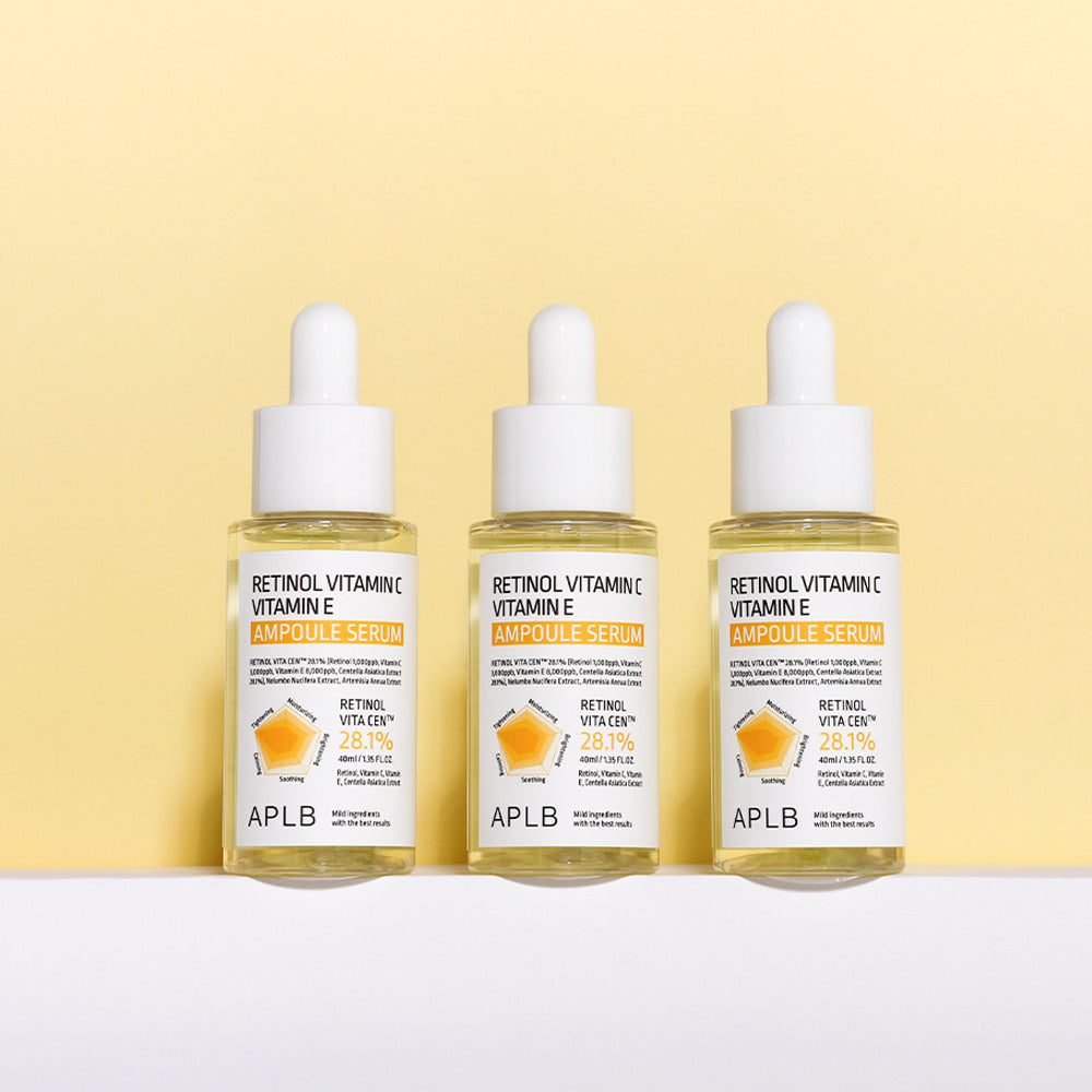 Three bottles of APLB Retinol Vitamin C Vitamin E Ampoule Serum 40ml displayed against a bright yellow background.