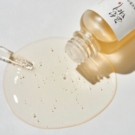 Dropper dispensing Beauty of Joseon Glow Serum Propolis & Niacinamide onto surface, highlighting K-Beauty silky smooth texture.