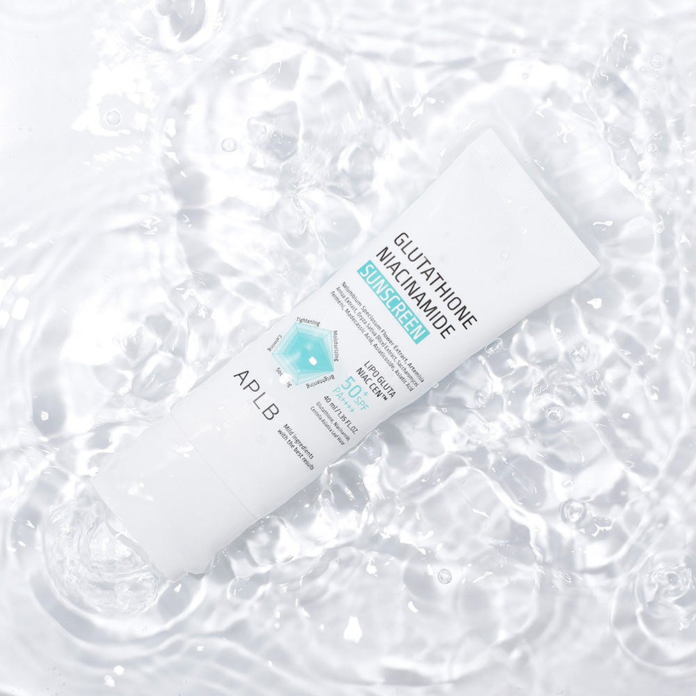 APLB Glutathione Niacinamide Sunscreen SPF50+ PA++++ displayed on water highlighting its lightweight hydrating Korean sunscreen formula.