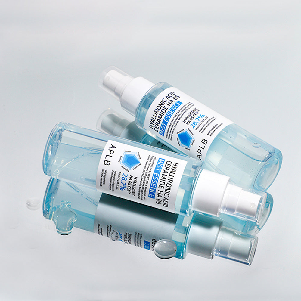 APLB Hyaluronic Acid Ceramide HA B5 Mist Essence bottles arranged on a reflective surface with water droplets