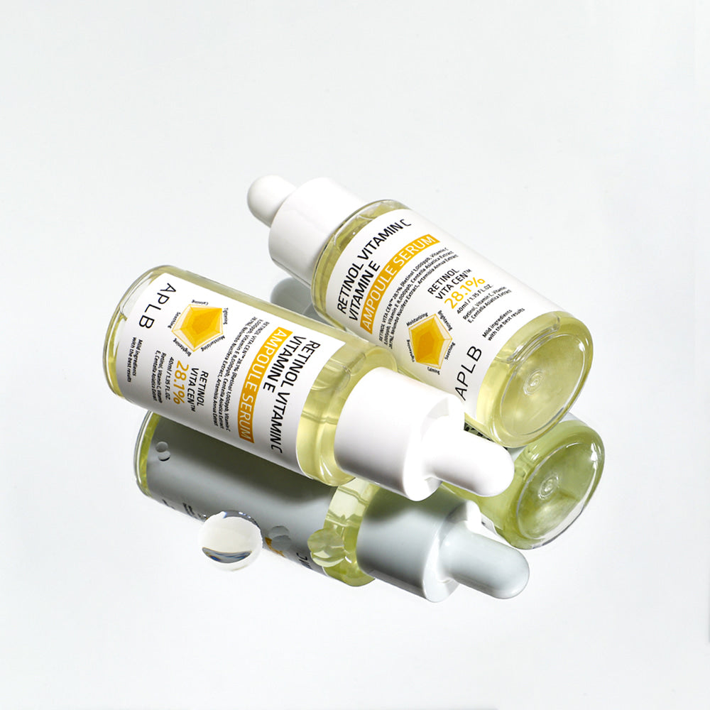 Two APLB Retinol Vitamin C Vitamin E Ampoule Serum bottles arranged with a reflective skincare styling effect.