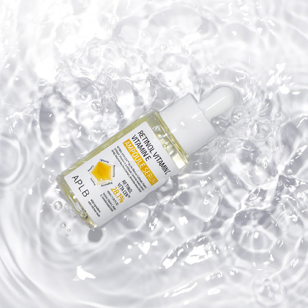 APLB Retinol Vitamin C Vitamin E Ampoule Serum 40ml surrounded by clear water to highlight its hydrating formula.